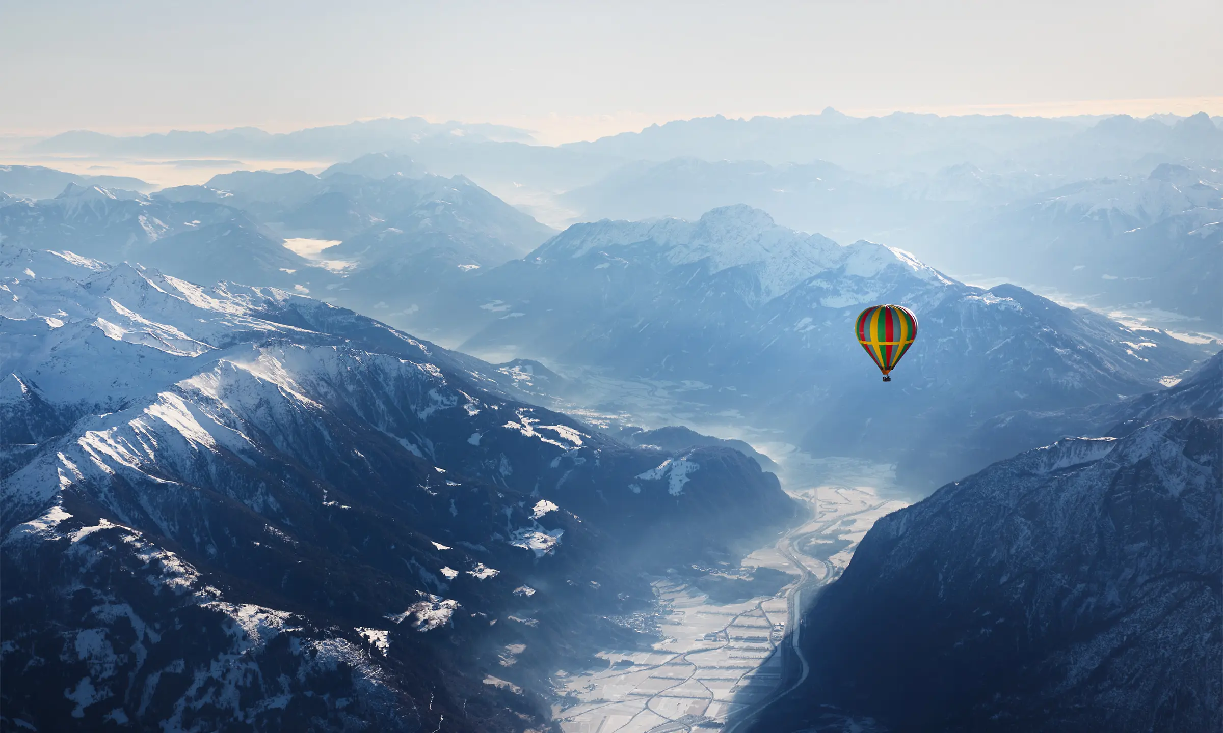 Hot air balloon floating over the Alps